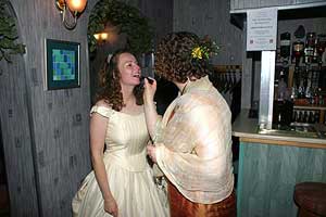 Bridesmaid touching up Bride's makeup